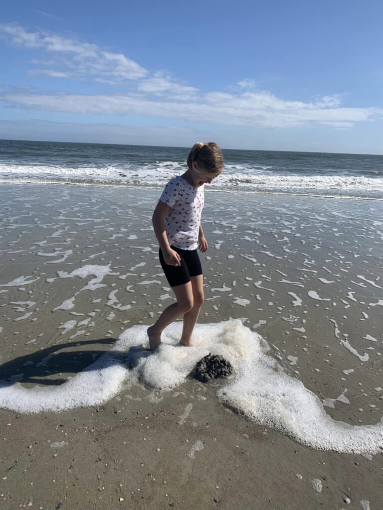 girl playing in ocean