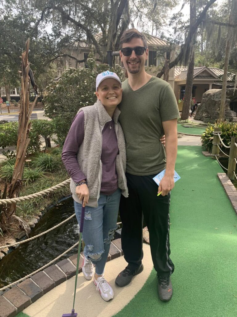 Husband and wife posing at mini golf course
