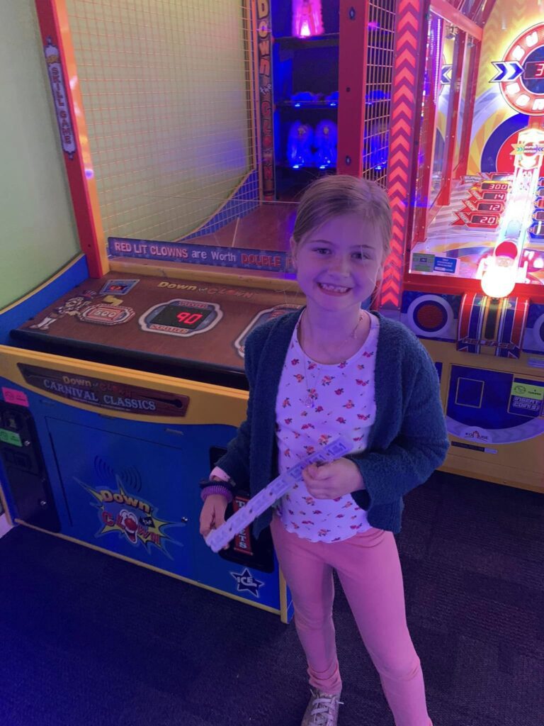 girl with tickets at arcade