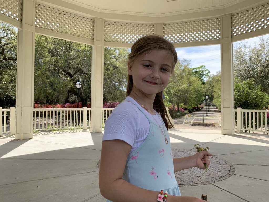 girl standing in gazebo smiling for the picture